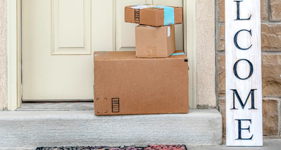 Packages on the doorstep of a home with a welcome sign in Birmingham